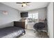 Cozy bedroom featuring hardwood floors, a ceiling fan, and a bright window at 18079 E 108Th Pl, Commerce City, CO 80022