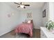 Bedroom featuring a ceiling fan, light-grey walls and brown wood-look floors at 18079 E 108Th Pl, Commerce City, CO 80022