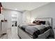 Cozy bedroom featuring hardwood floors, a nightstand, and closet storage space at 18079 E 108Th Pl, Commerce City, CO 80022