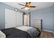 Comfortable bedroom with soft blue walls, hardwood floors, and ample closet space at 18079 E 108Th Pl, Commerce City, CO 80022