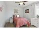 Bedroom featuring a ceiling fan, light-grey walls and brown wood-look floors at 18079 E 108Th Pl, Commerce City, CO 80022
