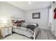 A charming bedroom features hardwood floors, a plush comforter, and a lamp-lit nightstand at 18079 E 108Th Pl, Commerce City, CO 80022