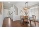 Dining area features a round wooden table, chandelier lighting, and plenty of natural light at 18079 E 108Th Pl, Commerce City, CO 80022