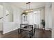 Bright dining area features modern lighting, a stylish table with bench seating, and ample natural light at 18079 E 108Th Pl, Commerce City, CO 80022