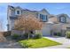 Charming two-story home with a well-maintained lawn and a two-car garage with grey sidings at 18079 E 108Th Pl, Commerce City, CO 80022