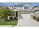Inviting two-story home featuring an attached two car garage, solar panels, and verdant lawn at 18079 E 108Th Pl, Commerce City, CO 80022