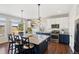 Stylish kitchen featuring a large island with seating, granite countertops, and stainless steel appliances at 18079 E 108Th Pl, Commerce City, CO 80022