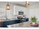 Charming kitchen area showcasing granite countertops, stainless steel appliances, and stylish lighting fixtures at 18079 E 108Th Pl, Commerce City, CO 80022