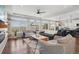 Spacious living room with large windows and an open floor plan, seamlessly flowing into the kitchen at 18079 E 108Th Pl, Commerce City, CO 80022