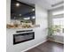 Bright living room showcases a modern fireplace, rustic wood mantle, and a large flatscreen television at 18079 E 108Th Pl, Commerce City, CO 80022