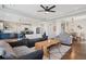 Open-concept living space featuring a spacious living room, kitchen with island seating, and adjacent dining area at 18079 E 108Th Pl, Commerce City, CO 80022
