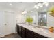 Modern main bathroom with double sinks, granite countertops, and a tiled shower at 18079 E 108Th Pl, Commerce City, CO 80022