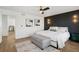 Bright main bedroom with modern decor, wood accent wall, and comfortable furnishings at 18079 E 108Th Pl, Commerce City, CO 80022