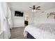Bright main bedroom with an ensuite bathroom showcases a ceiling fan and contemporary decor at 18079 E 108Th Pl, Commerce City, CO 80022