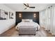 Inviting main bedroom with a decorative accent wall, ceiling fan, and two large windows at 18079 E 108Th Pl, Commerce City, CO 80022
