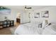 Comfortable main bedroom with a view of the en suite bathroom, wood floors, and decor at 18079 E 108Th Pl, Commerce City, CO 80022
