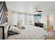 Spacious main bedroom with streaming TV, white linens, and large windows at 18079 E 108Th Pl, Commerce City, CO 80022