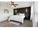 Beautiful main bedroom features a stylish accent wall, contemporary lighting, and large windows at 18079 E 108Th Pl, Commerce City, CO 80022