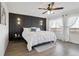 Beautiful main bedroom features a stylish accent wall, contemporary lighting, and large windows at 18079 E 108Th Pl, Commerce City, CO 80022