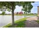 A picturesque view of the pond with a walking trail and barn at 18079 E 108Th Pl, Commerce City, CO 80022