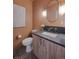 Stylish powder room with an oval mirror and modern fixtures at 2450 S Cherokee St, Denver, CO 80223