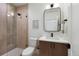 Stylish bathroom featuring shower with decorative tile, toilet, and sink at 2450 S Cherokee St, Denver, CO 80223