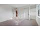 Neutral bedroom featuring an open closet, a large window, and a staircase to the next level at 2450 S Cherokee St, Denver, CO 80223