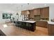 Spacious kitchen featuring a large center island, modern lighting, and stainless appliances at 2450 S Cherokee St, Denver, CO 80223