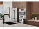 Close up of a modern kitchen showing stainless steel appliances and quartz countertops at 2450 S Cherokee St, Denver, CO 80223