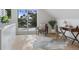 Sunlit living area with desk and large window and sliding glass doors at 2450 S Cherokee St, Denver, CO 80223