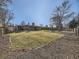 Spacious backyard with mature trees, a brick border, and a wood fence at 3361 W Saratoga Ave, Englewood, CO 80110