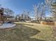 Wide angle shot of a spacious backyard featuring a covered patio and a wood fence at 3361 W Saratoga Ave, Englewood, CO 80110