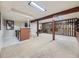 Finished basement with a bar area, carpet flooring, and decorative wood details at 3361 W Saratoga Ave, Englewood, CO 80110