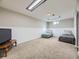 Finished basement with neutral carpet, wainscoting and a TV with 2 twin beds at 3361 W Saratoga Ave, Englewood, CO 80110