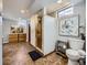 Bathroom with brown tile, walk-in shower, city art, and a decorative ladder at 3361 W Saratoga Ave, Englewood, CO 80110