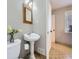 Classic bathroom with pedestal sink, decorative tile floors, and a window at 3361 W Saratoga Ave, Englewood, CO 80110