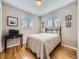 Bright bedroom with hardwood floors, a bed, and two windows at 3361 W Saratoga Ave, Englewood, CO 80110