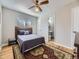 Bright bedroom featuring a ceiling fan, wooden floors and a connected bathroom at 3361 W Saratoga Ave, Englewood, CO 80110