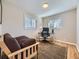 Spare bedroom featuring wood frame futon, office space and a tan rug at 3361 W Saratoga Ave, Englewood, CO 80110