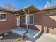 Front entrance featuring a brick facade, decorative ironwork, and covered porch, located at 3361 at 3361 W Saratoga Ave, Englewood, CO 80110