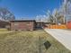 Charming brick ranch home with a well-maintained lawn and a long driveway leading to a garage at 3361 W Saratoga Ave, Englewood, CO 80110