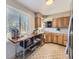 Efficient kitchen layout with stainless steel appliances, wood cabinetry and natural lighting at 3361 W Saratoga Ave, Englewood, CO 80110
