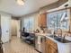 Functional kitchen area features stainless steel appliances and ample counter space with a cozy breakfast nook at 3361 W Saratoga Ave, Englewood, CO 80110