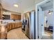 Well-lit kitchen featuring stainless steel appliances, oak cabinets, and a doorway leading to a bedroom at 3361 W Saratoga Ave, Englewood, CO 80110