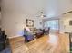 Bright living room with hardwood floors, neutral decor, and a cozy seating arrangement at 3361 W Saratoga Ave, Englewood, CO 80110