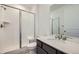 Clean bathroom features a tile shower with glass door, sleek vanity, and modern fixtures at 4619 Windmill Dr, Brighton, CO 80601