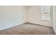 Clean and spacious bedroom featuring a neutral carpet, natural light, and a walk-in closet at 4619 Windmill Dr, Brighton, CO 80601