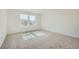 Cozy bedroom with plush carpeting and natural light from two large windows at 4619 Windmill Dr, Brighton, CO 80601