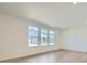 Spacious room with recessed lighting, hardwood floors and large windows looking out onto the neighborhood at 4619 Windmill Dr, Brighton, CO 80601
