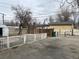 Spacious backyard featuring a concrete patio, wooden fence, and mature trees offering a blend of privacy and outdoor living at 1120 Dayton St, Aurora, CO 80010